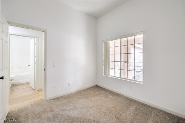 spare room featuring light colored carpet