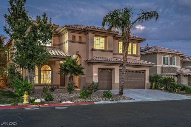 mediterranean / spanish home featuring a garage