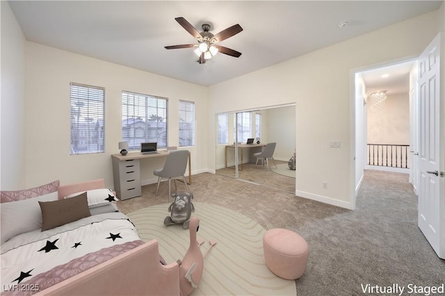 living room featuring a ceiling fan, baseboards, and carpet floors
