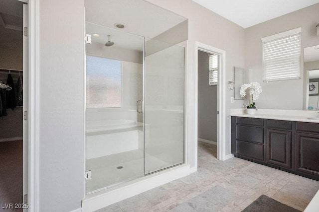 bathroom featuring vanity, an enclosed shower, and a wealth of natural light