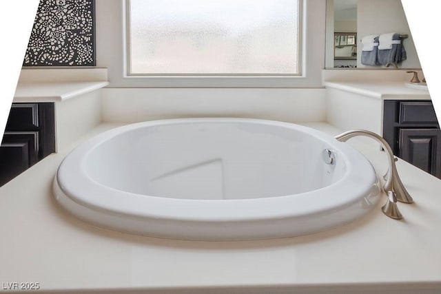 bathroom with a tub to relax in and a wealth of natural light