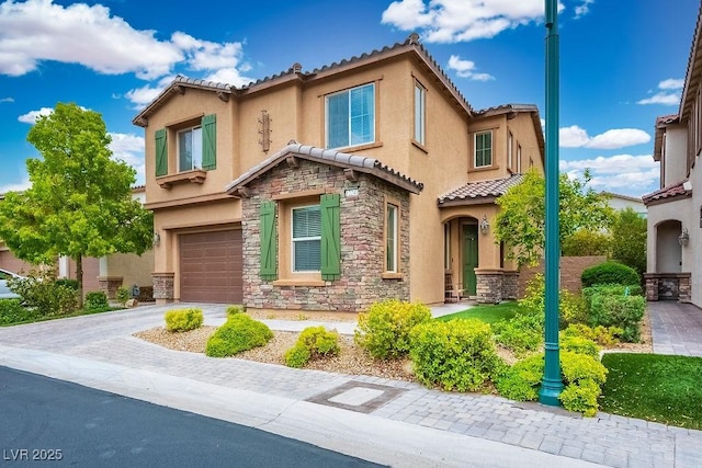 mediterranean / spanish-style house with a garage