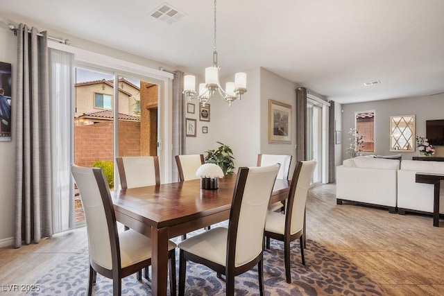 dining room featuring a notable chandelier and a healthy amount of sunlight