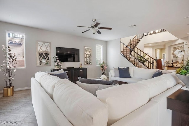 living room featuring ceiling fan, light tile patterned floors, and a wealth of natural light