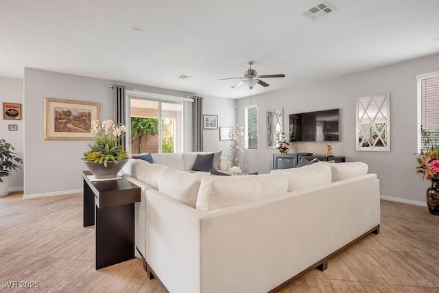 living room with light tile patterned flooring and ceiling fan