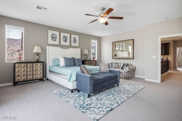 bedroom with multiple windows, ceiling fan, and carpet