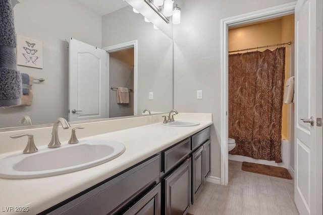 full bathroom with vanity, hardwood / wood-style floors, toilet, and shower / bath combo with shower curtain