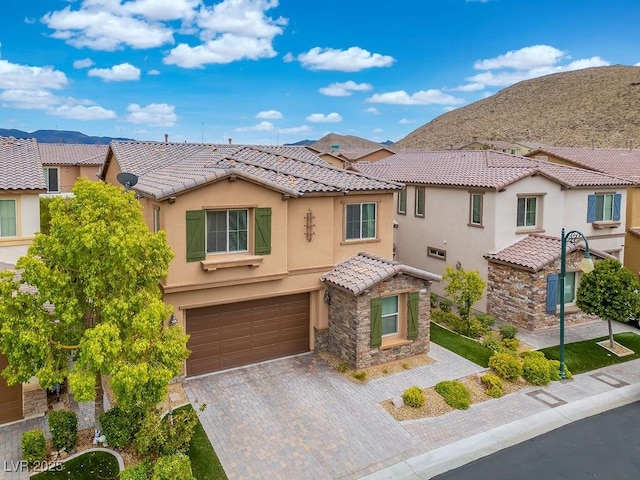 view of front of home featuring a mountain view and a garage