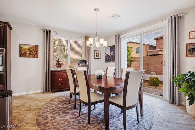 dining room featuring light tile patterned flooring, baseboards, a chandelier, and visible vents