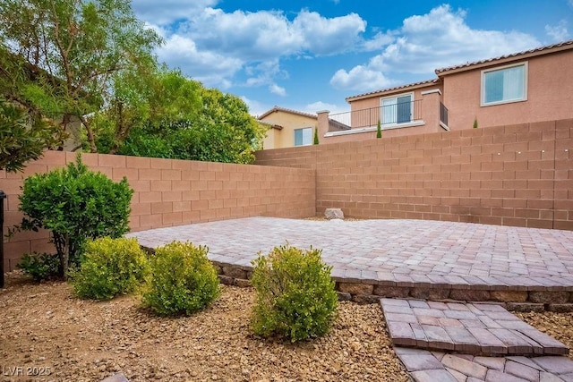 view of yard with fence and a patio