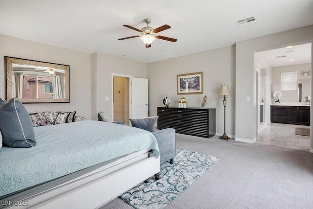 bedroom featuring visible vents, light carpet, baseboards, ceiling fan, and connected bathroom