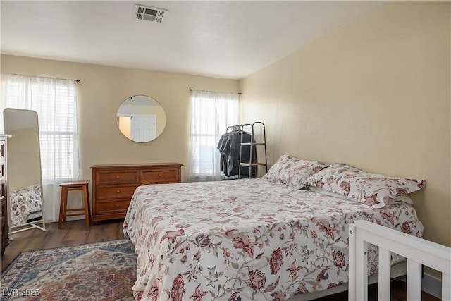 bedroom with dark wood-type flooring