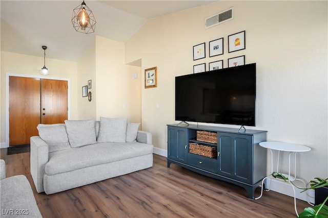 living room with dark wood-type flooring and vaulted ceiling