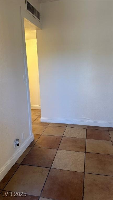 unfurnished room with light tile patterned floors