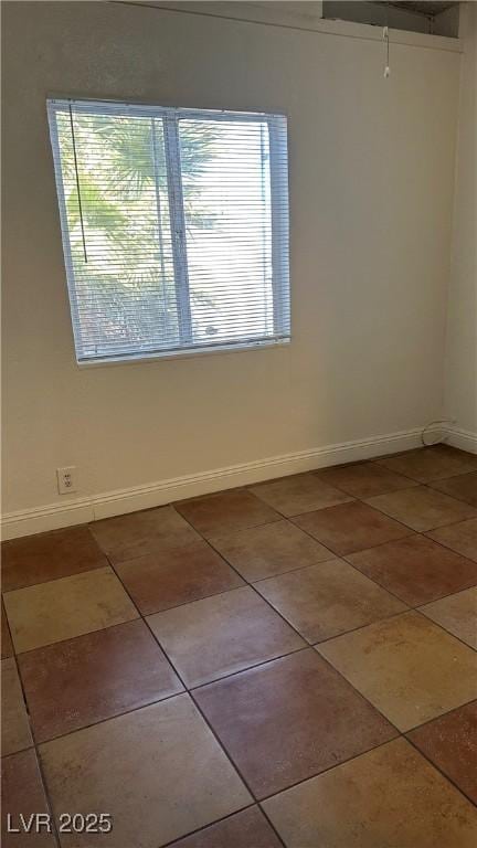 unfurnished room with tile patterned flooring