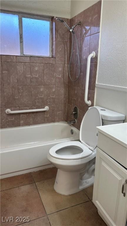 full bathroom featuring tiled shower / bath, vanity, toilet, and tile patterned floors