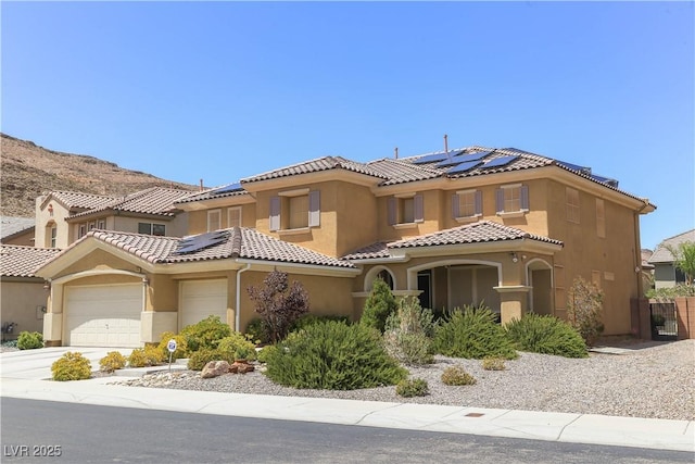 mediterranean / spanish-style house with solar panels