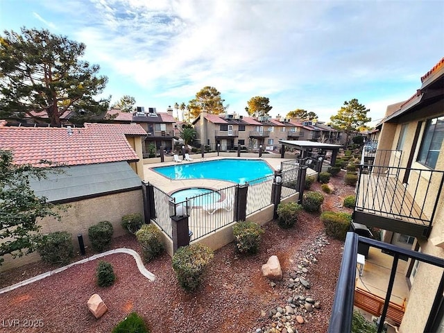 pool featuring a residential view, fence, and a patio