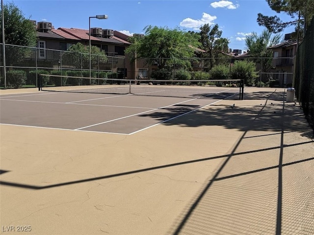 view of tennis court with fence