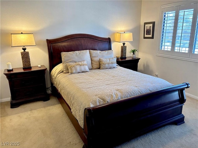 bedroom featuring baseboards and carpet flooring