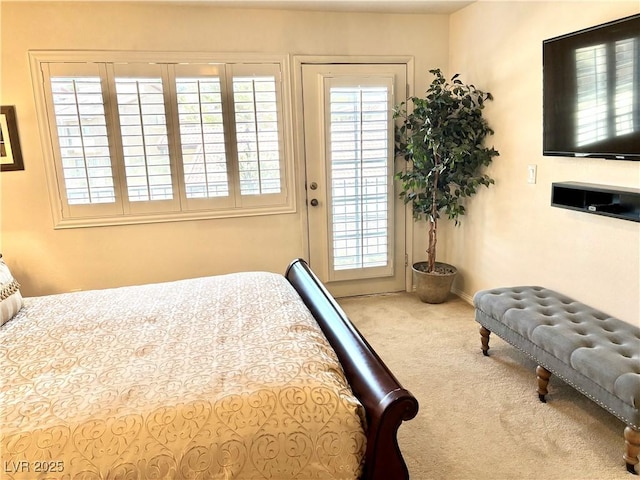 carpeted bedroom featuring access to outside and multiple windows