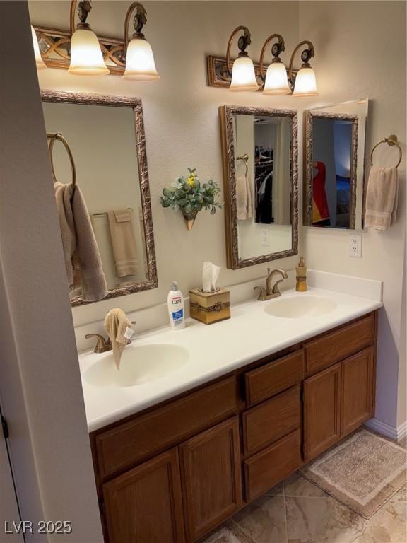 full bathroom featuring double vanity and a sink