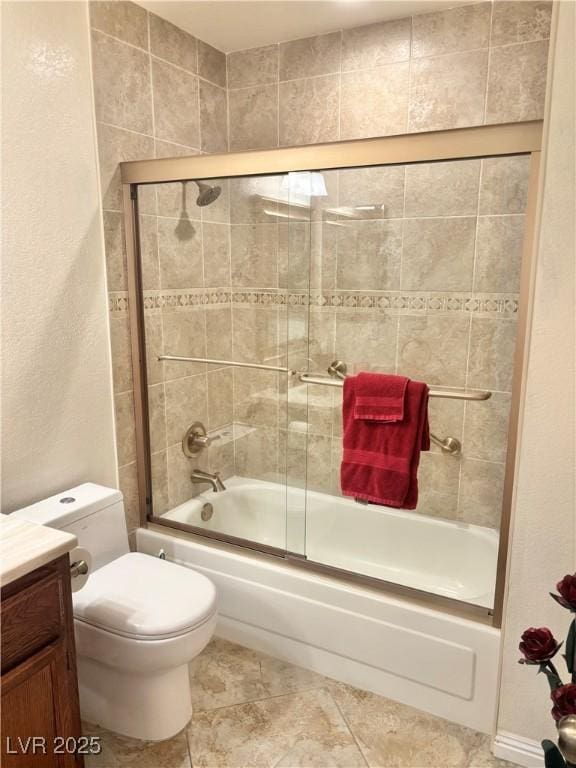 full bath featuring tile patterned flooring, shower / bath combination with glass door, vanity, and toilet