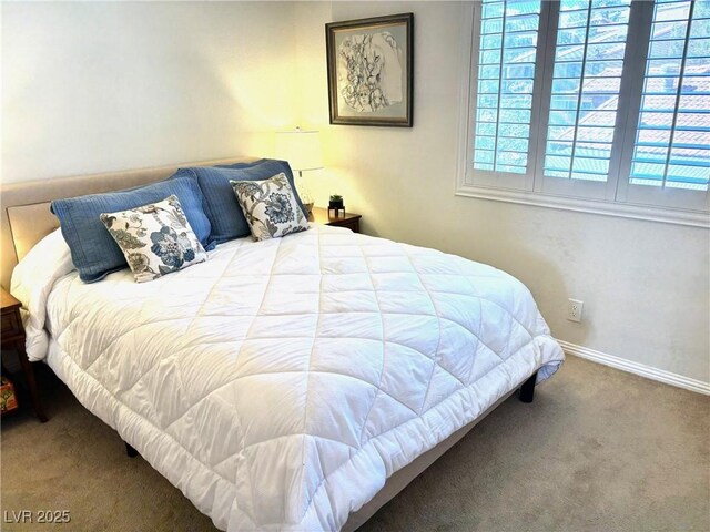 bedroom featuring carpet floors and baseboards