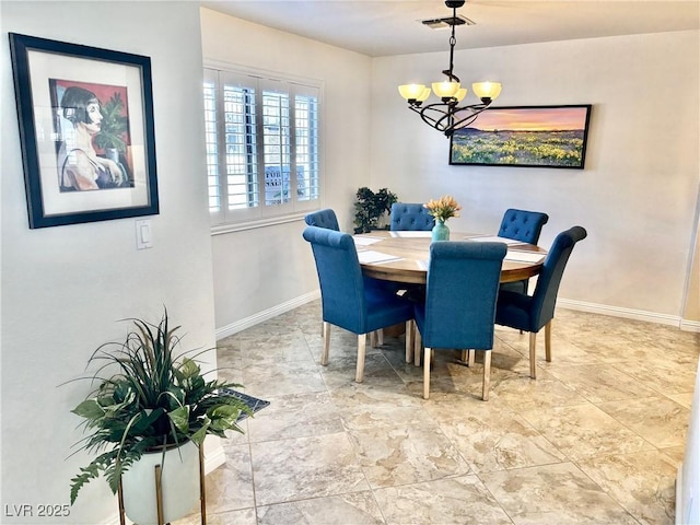 dining area with visible vents, a notable chandelier, and baseboards