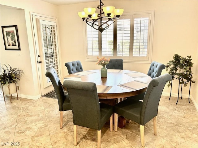 dining area featuring baseboards and an inviting chandelier