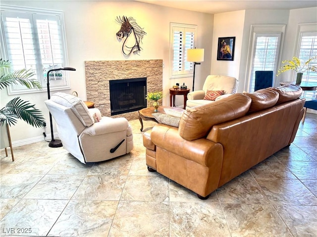 living area with a fireplace and baseboards