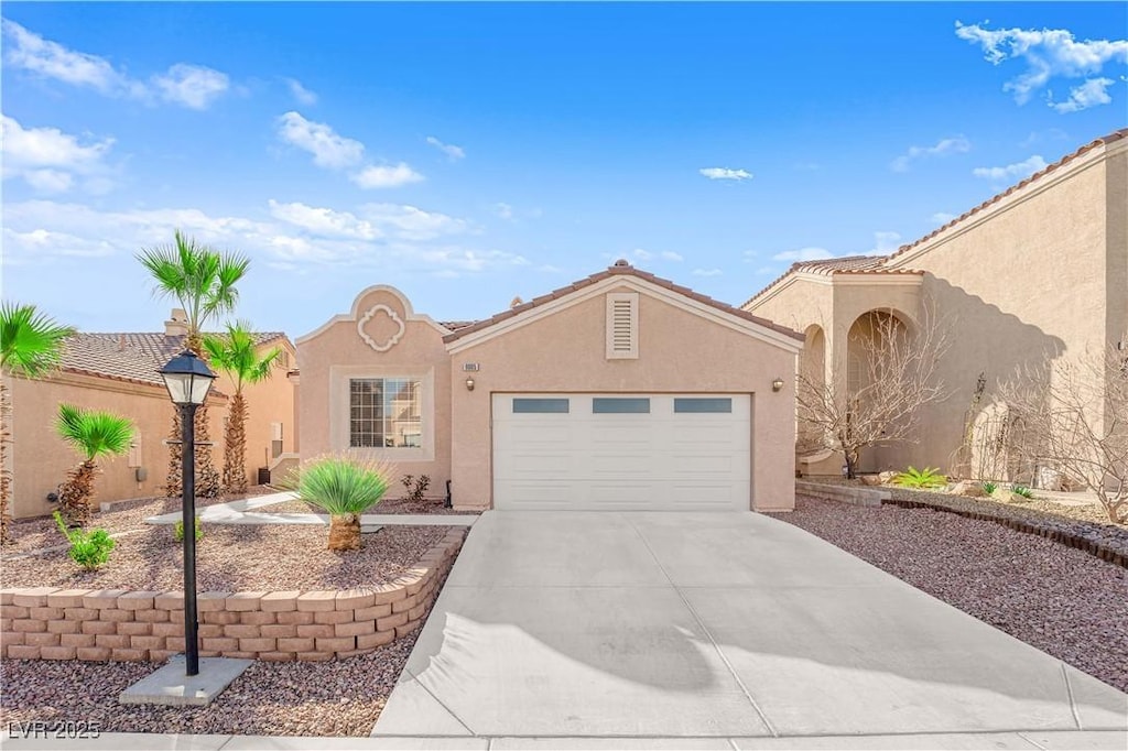 mediterranean / spanish-style house with a garage