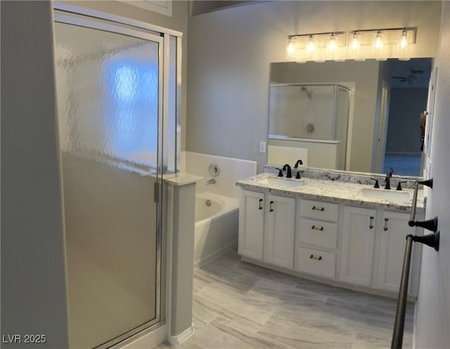 bathroom with vanity and independent shower and bath