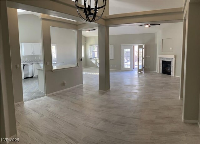 interior space featuring ceiling fan with notable chandelier