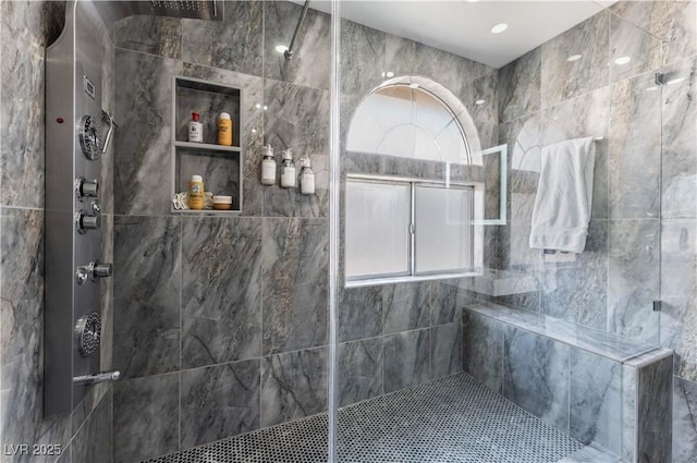 bathroom featuring tiled shower