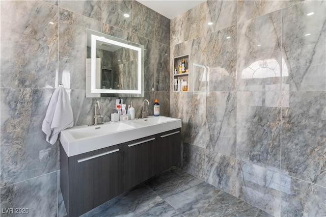 bathroom with vanity and tile walls