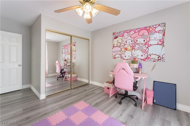 home office with hardwood / wood-style flooring and ceiling fan