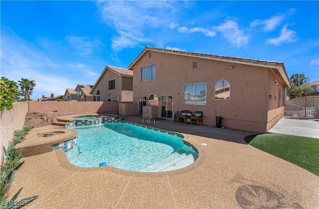 view of pool with an in ground hot tub and a patio