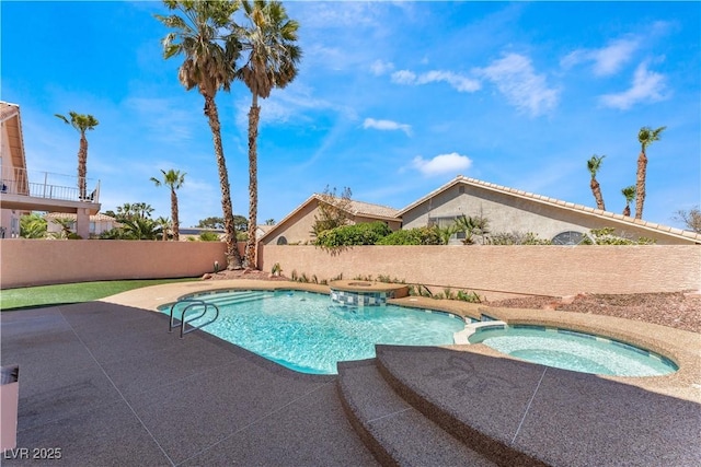 view of swimming pool with an in ground hot tub and a patio area