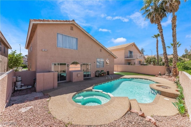 view of pool with an in ground hot tub