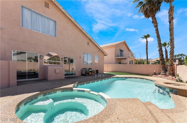 view of pool with an in ground hot tub