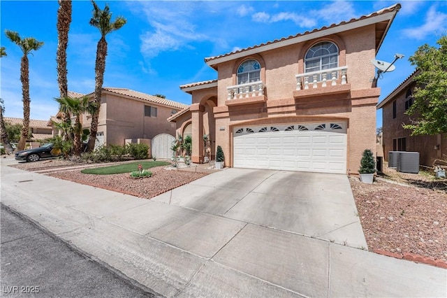 mediterranean / spanish home with a garage and central AC