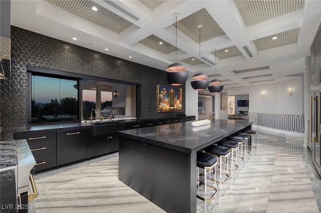 bar featuring coffered ceiling, beam ceiling, hanging light fixtures, an accent wall, and marble finish floor