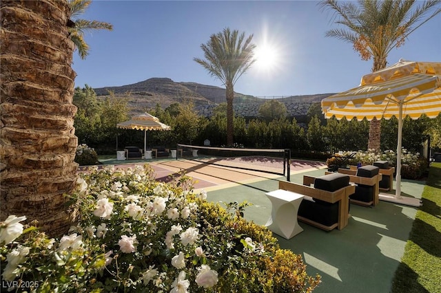 exterior space with a mountain view and a tennis court