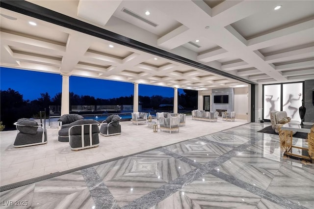 patio at night featuring visible vents, an outdoor living space, and an outdoor pool