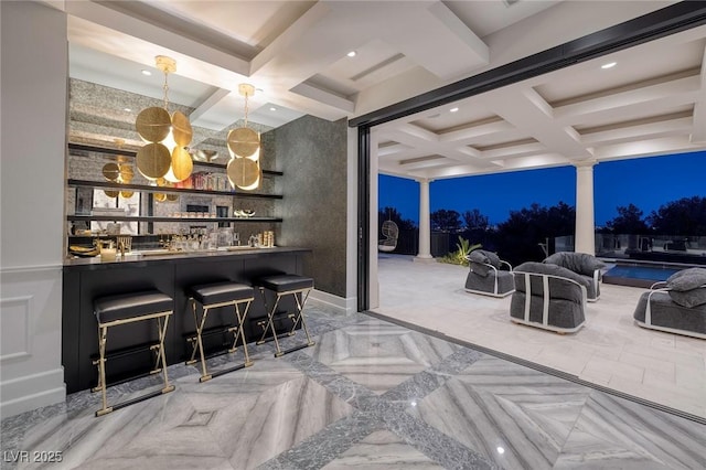 bar with beamed ceiling, bar, coffered ceiling, and decorative columns