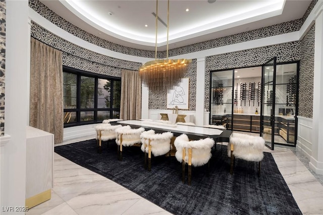 dining space featuring a tray ceiling, a decorative wall, recessed lighting, and marble finish floor