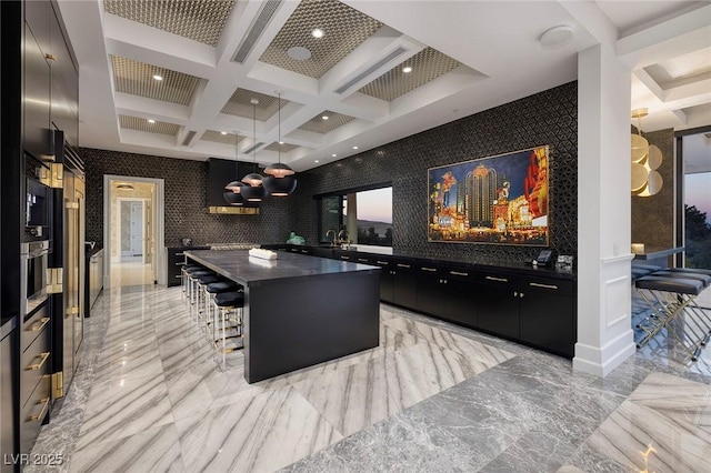 kitchen featuring dark countertops, marble finish floor, dark cabinetry, and coffered ceiling