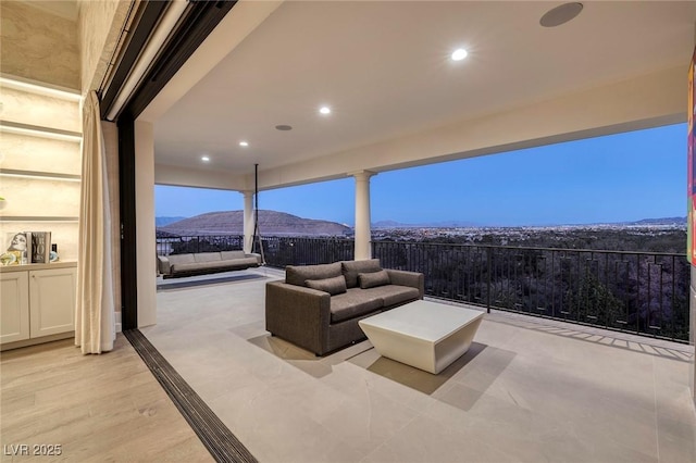 view of patio / terrace with a mountain view and an outdoor hangout area