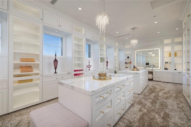 interior space featuring built in features, visible vents, recessed lighting, crown molding, and a notable chandelier